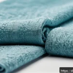Home 16 재생 섬유의 품질 기준과 인증 - A high-quality recycled fiber textile close-up, showing a soft, even fabric texture with subtle colo...